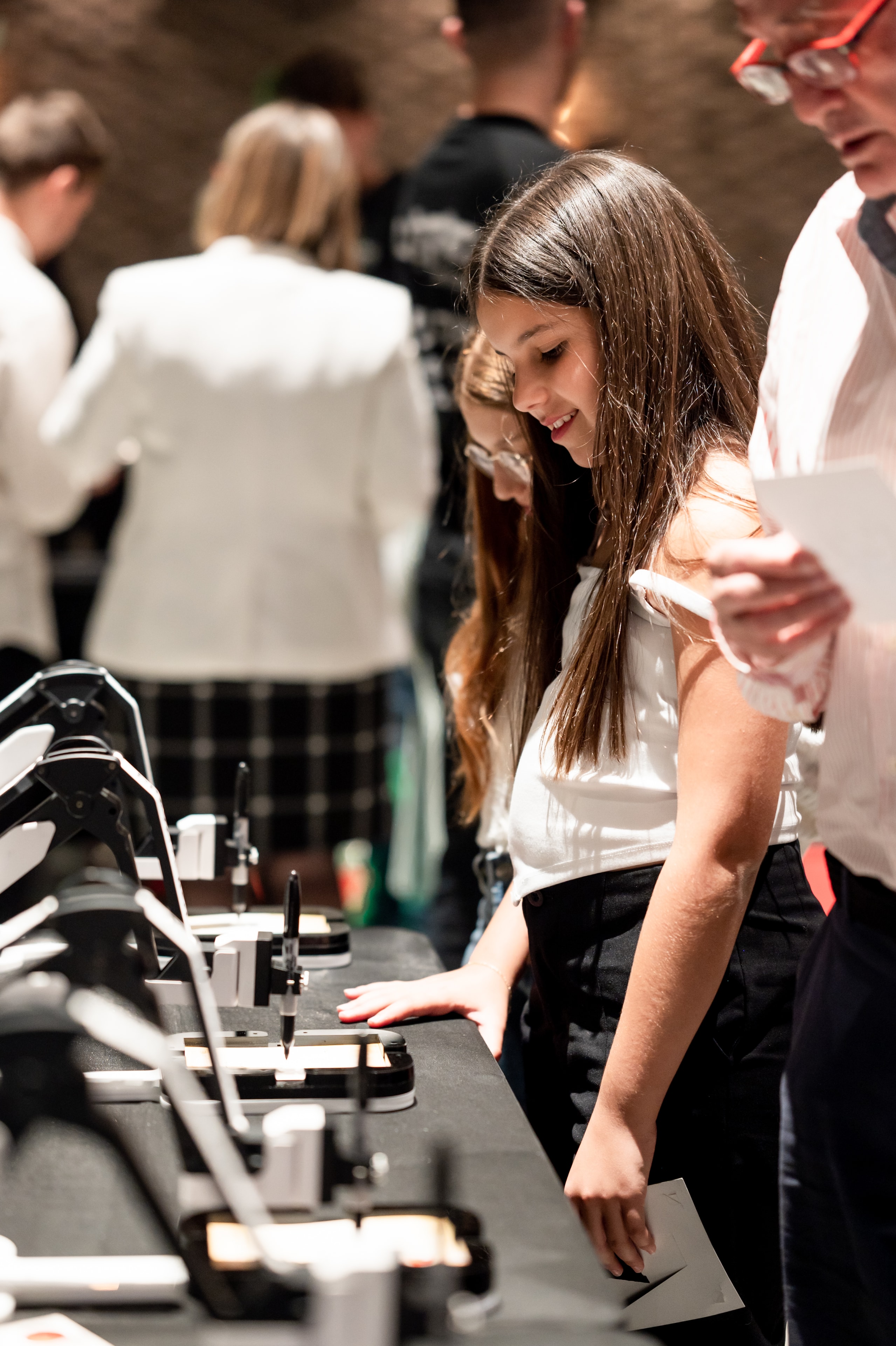 Guests enjoying the DrawMeBot AI art experience